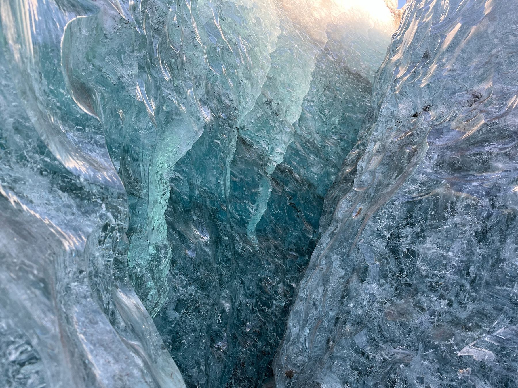 Paredes de hielo translúcido y azul dentro de una cueva glaciar